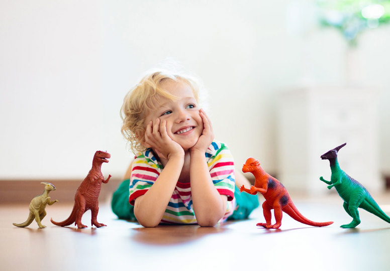 International Product Safety Week Child playing with dinosaur toys