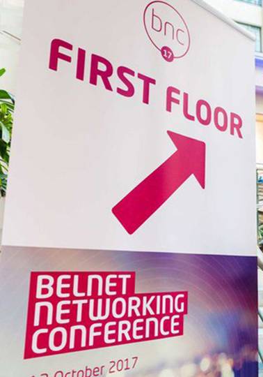 Surfing whilst networking Two men walking up stairs to building