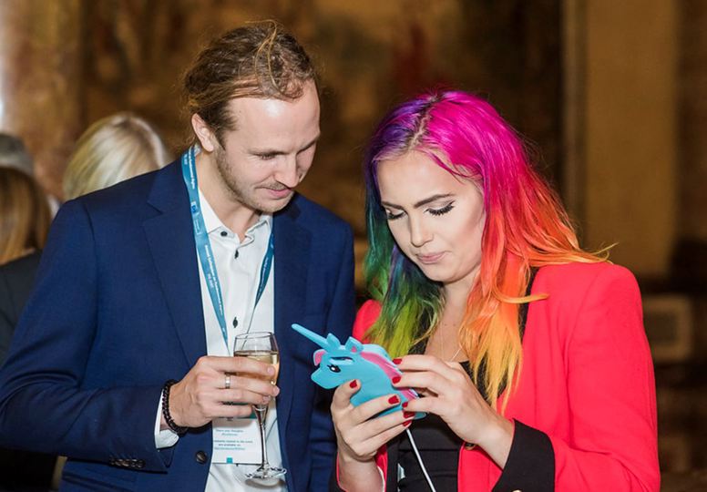 Young man and woman looking at an animal-shaped device
