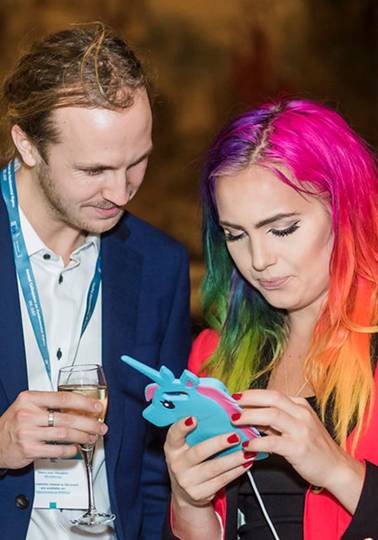 Promoting women’s rights Young man and woman looking at an animal-shaped device