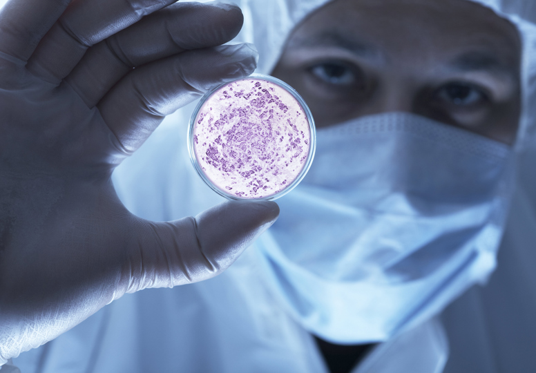 Keeping specialists up-to-date on EU research Man in protective lab gear holding petri dish