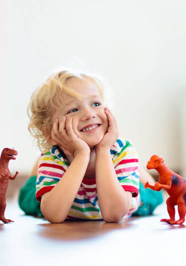 International Product Safety Week Child playing with dinosaur toys