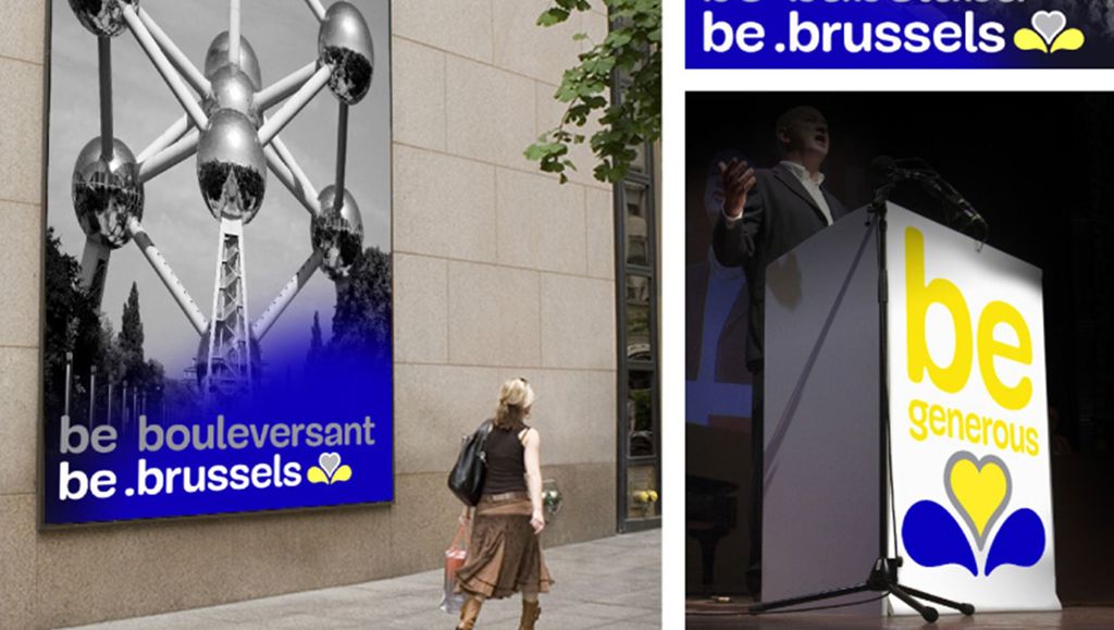 ‘be.brussels’— a platform that gives the population a voice Lady walking past photo of Atomium on a wall. Man talking behind rostrum