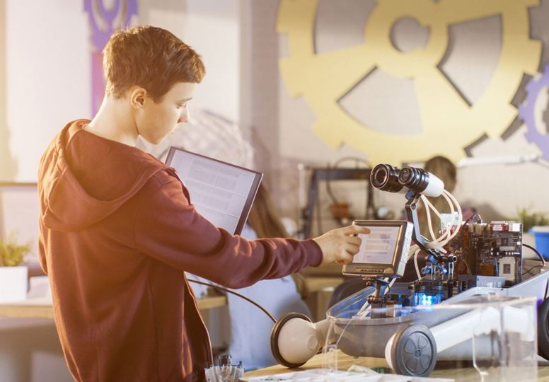 Live-in robot story goes viral Boy touching the screen of a robot