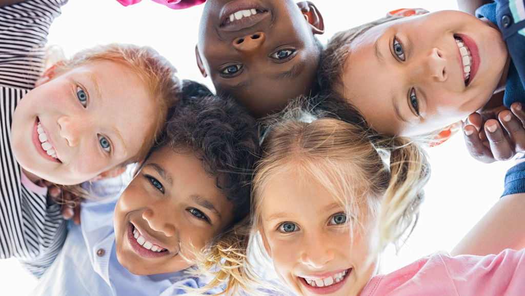 View of happy children smiling in front of a camera