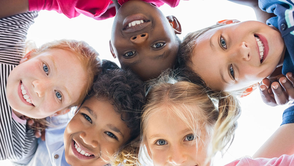 Debating children’s rights online View of happy children smiling in front of a camera
