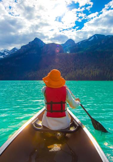 A lifeline on the trip of a lifetime Woman canoeing on Lak Louise, Canada.