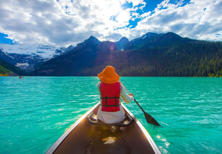A lifeline on the trip of a lifetime Woman canoeing on Lak Louise, Canada.