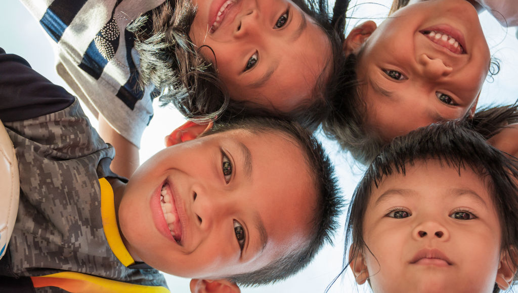 Strengthening ties with the Indo-Pacific region Group of Indonesian children hugging and looking down into the camera smiling